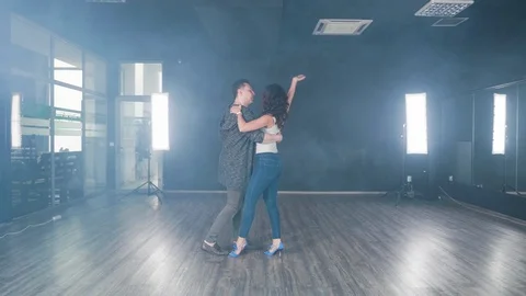 Pretty couple in casual clothes practicing new dance moves Stock Footage 107427981