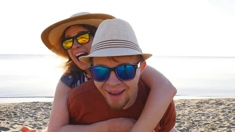 Pretty couple in love having fun on beach holidays together Stock Footage