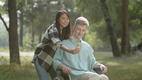 A pretty couple is making selfies together, smiling and posing in the public Stock Footage 173847129
