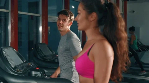 Pretty couple training on a treadmill Video stock 65178291
