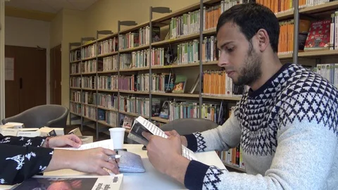 Pretty Couple Working In a Library Stock Footage 123053212