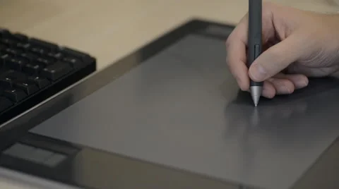 Pretty creative designer using digitizer in office draws to it the necessary Vidéo 56556761