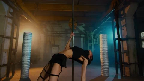 Pretty dancer jumping up near the pylon. girl in black leather underwear Stock Footage 134746229