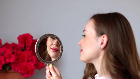 Pretty face reflection in bronze vintage mirror, smiling girl admiring herself Stock Footage 137931356
