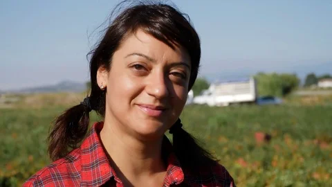 Pretty farmer smiling at camera, close up portrait Stock Footage 81514031