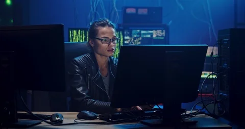 Pretty female Caucasian software developer in glasses working over the hacking Stock Footage 124340727