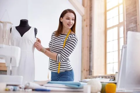 Pretty female dressmaker watching tutorial Stock Photos