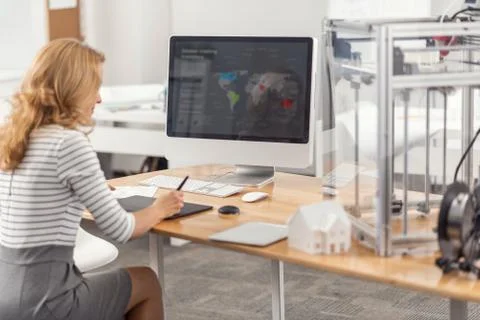 Pretty female engineer developing presentation on computer Foto stock