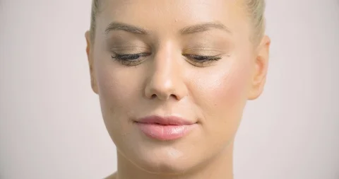 Pretty female model bites down on a cherry tomato and it squirts juice. Stock Footage 117343080