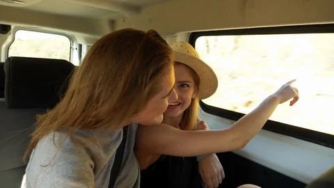 Pretty Female Models Talking in a Van Enjoying the Scenery Stock Footage 114323892
