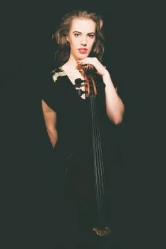 Pretty Female Musician Standing behind her Cello Stock Photos