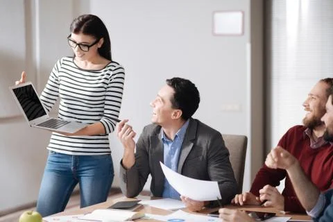 Pretty female presenting her project Stock Photos