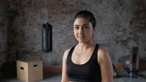 Pretty female professional posing camera after fitness training Stock Footage 143447174