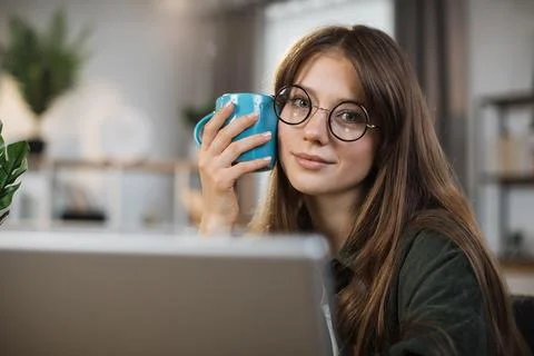 Pretty female software developer using modern laptop for remote work at home Foto stock