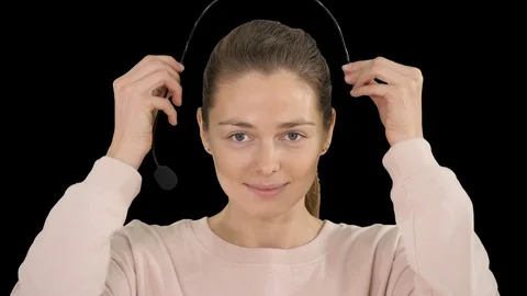 Pretty female support center operator with headset smiling to camera, Alpha Stock-Footage 116003418