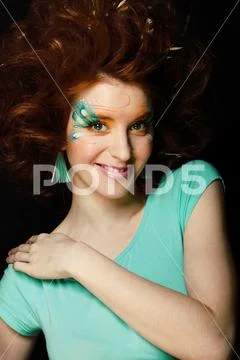 Pretty funny girl with art make up, closeup floral print on face Stock Photos