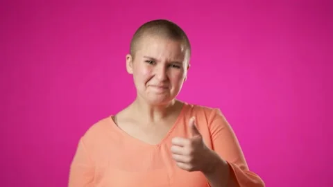 Pretty gender fluid non binary young woman 20s with hearing aid turns around Stock Footage 222654831