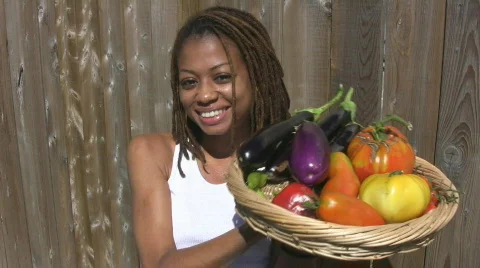 Pretty girl with basket of vegetables. Stock Footage