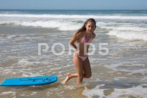 Pretty Girl On The Beach Surfing On The Body Board