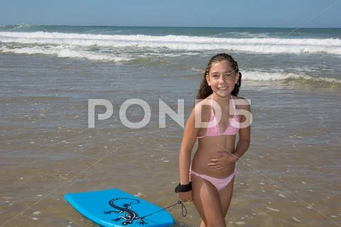 Pretty Girl On The Beach Surfing On The Body Board
