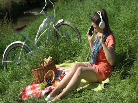 Pretty girl dancing while listening music on headphones, steadycam shot Stock Footage
