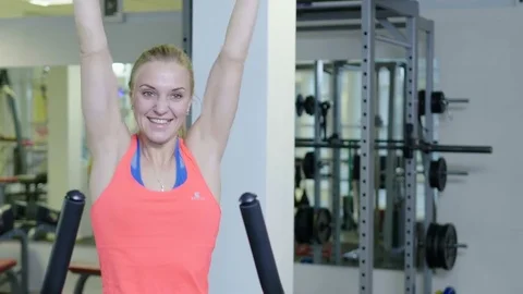 Pretty girl doing exercise with exercise bike in the gym Stock Footage 72143670