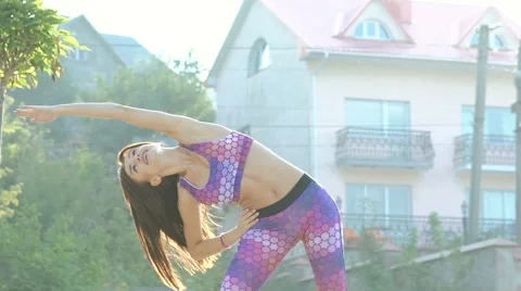 Pretty girl doing exercise with flexibility outdoor Stock Footage