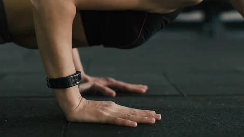 Pretty girl doing push ups at gym background Stock Footage 94565906