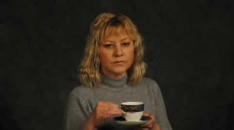Pretty girl drinking from a tea cup Stock Footage 12021092