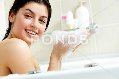 Pretty girl with foam in hands looking at camera Stock Photos