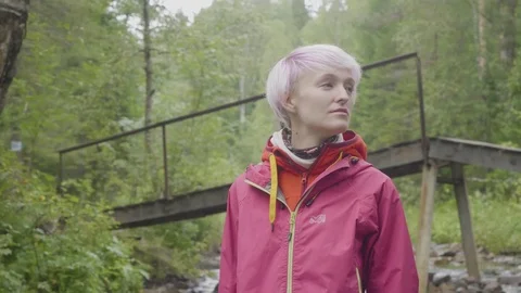 A pretty girl in the forest looks back. Blond girl in the forest looking around Stock Footage