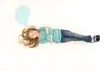 The pretty girl lay on the floor near the dialog signs. View from above Photo