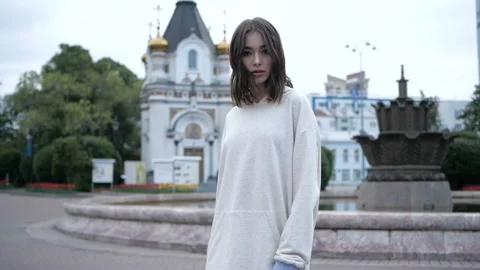 Pretty girl is looking at camera while walking Stock Footage 91893086