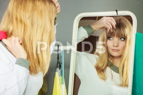 Pretty Girl Looking Into Mirror.
