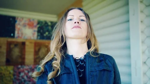 Pretty girl posing with two throwing axes Stock Footage 81927409