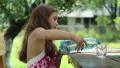 Pretty girl pours water from bottle into a glass HD Footage