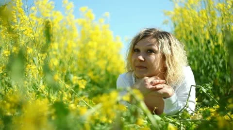 Pretty girl   in a rape field Stock Footage 11123396