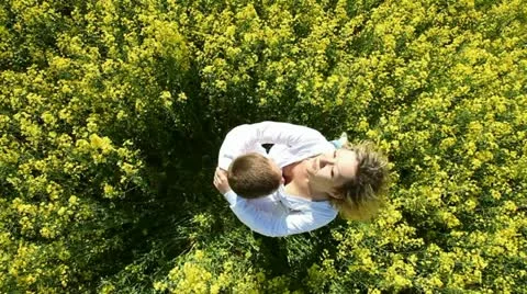 Pretty girl in a rape field, view from above Stock Footage 11115134