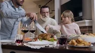 Pretty Girl Showing Her Father What Part Of Roast Turkey She Wants To Eat During Stock Footage