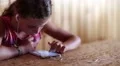 Pretty girl sits at the table and uses smartphone HD Footage