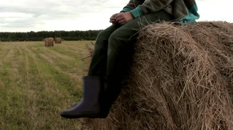 Pretty girl is sitting on haystack  Stock Footage 54349387