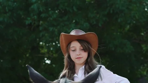 Pretty girl sitting on the horse, smiling and caresses it. Slowly Stock Footage
