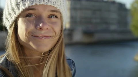 Pretty girl sitting by the river while in the city. Stock Footage 63032672