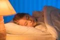 The pretty girl sleeping on the bed. Evening night time Photo