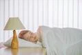 The pretty girl sleeping on the bed with white linens Photo