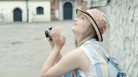 Pretty girl in sleeveless shirt doing photos while sightseeing town, steadycam s Stock Footage
