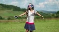 Pretty girl with smartphone stands on the meadow, listens to music and dance HD Footage
