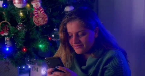 Pretty  girl smiling while congratulating Christmas chatting on the phone Stock Footage 144584174