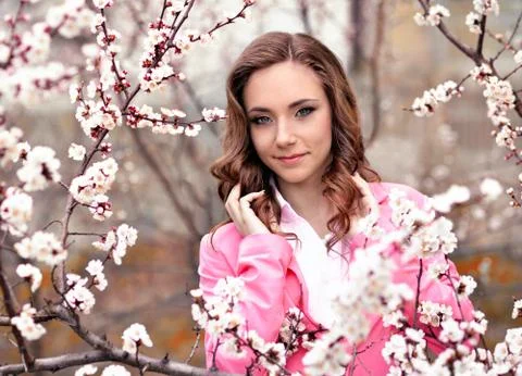 Pretty girl in spring garden with flowers Stock Photos