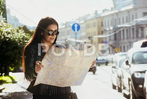 Pretty girl stands with city map Stock Photos
